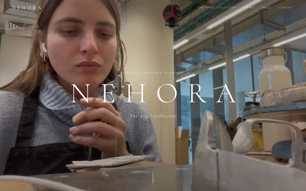 Nehora jewelry website — cinematic studio footage behind elegant serif type